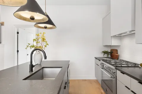 a kitchen with a stove a sink and a microwave