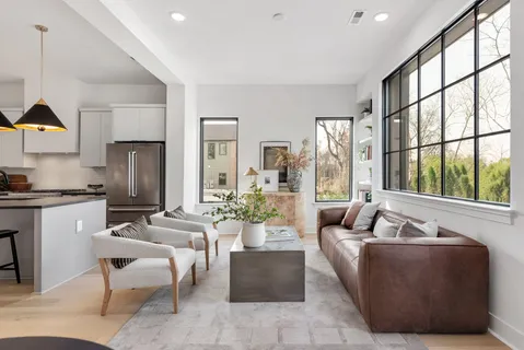 a living room with furniture and floor to ceiling windows