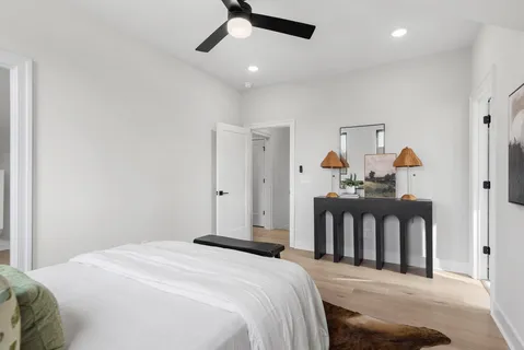 a bedroom with a bed and a chandelier