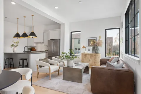 a living room with fireplace furniture and a large window