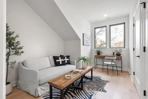 a living room with furniture and a potted plant