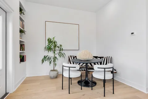 a view of a livingroom with furniture and a potted plant