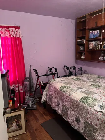 a bedroom with a bed a dresser and book shelf