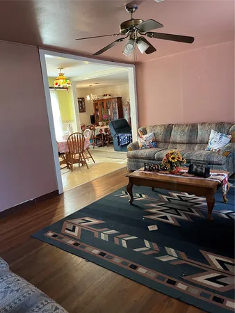 a living room with wooden floor and furniture
