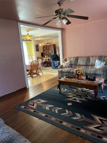a living room with wooden floor and furniture