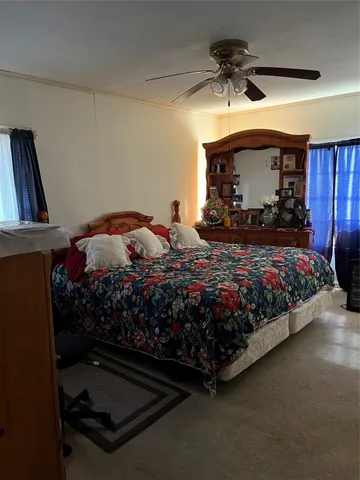 a bedroom with a bed a window and a chandelier