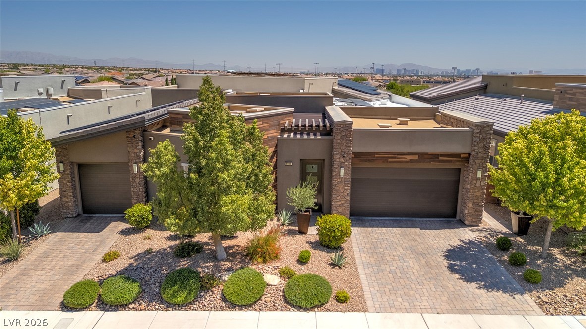 6014 Willow Ridge Court Las Vegas, NV 89135 - Photo 1 of 99 This modern desert home features clean lines, stone accents, and inviting landscaping, offering a blend of style and nature.