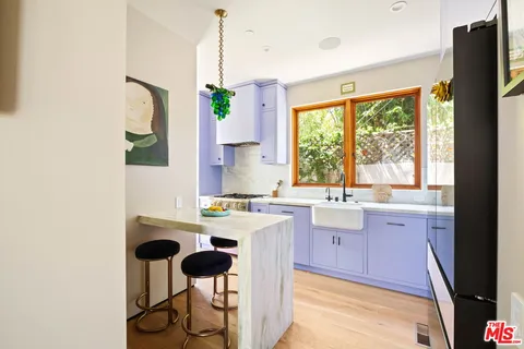 a kitchen with a sink stove and refrigerator