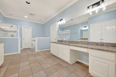 a large bathroom with a granite countertop sink and a mirror