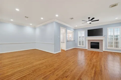 a view of empty room with wooden floor and fireplace