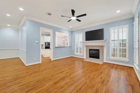 a view of empty room with wooden floor and fireplace