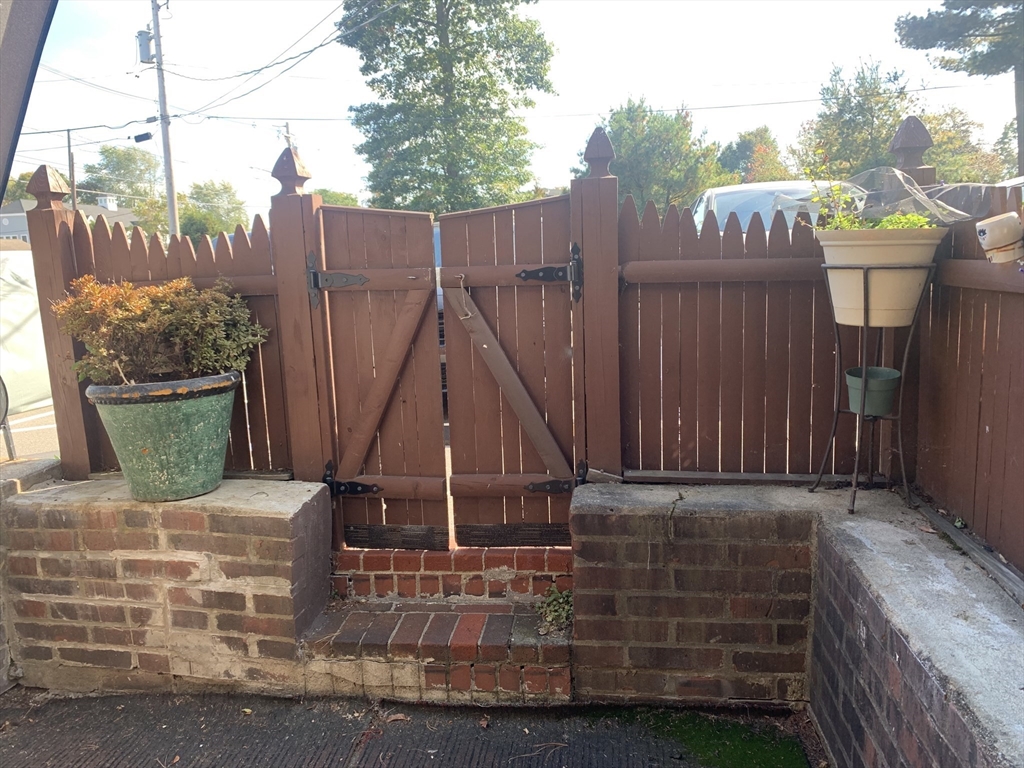 36 Main Street, Unit 1 North Reading, MA 01864 - Photo 2 of 4 a wooden bench sitting in front of a house