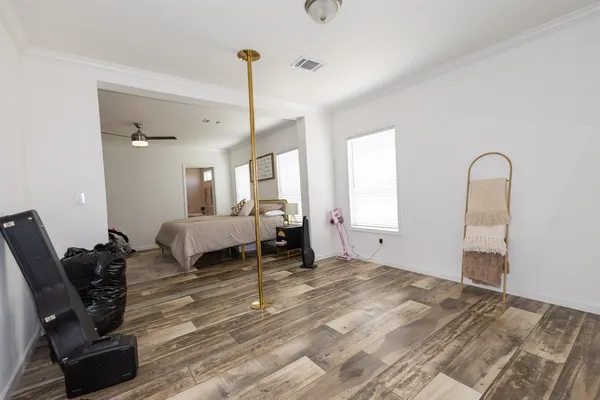 a bed sitting in a bedroom next to a window