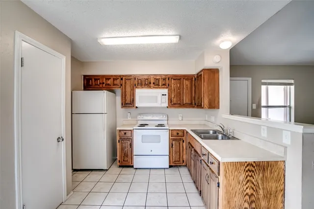 a kitchen with a stove a refrigerator and a sink