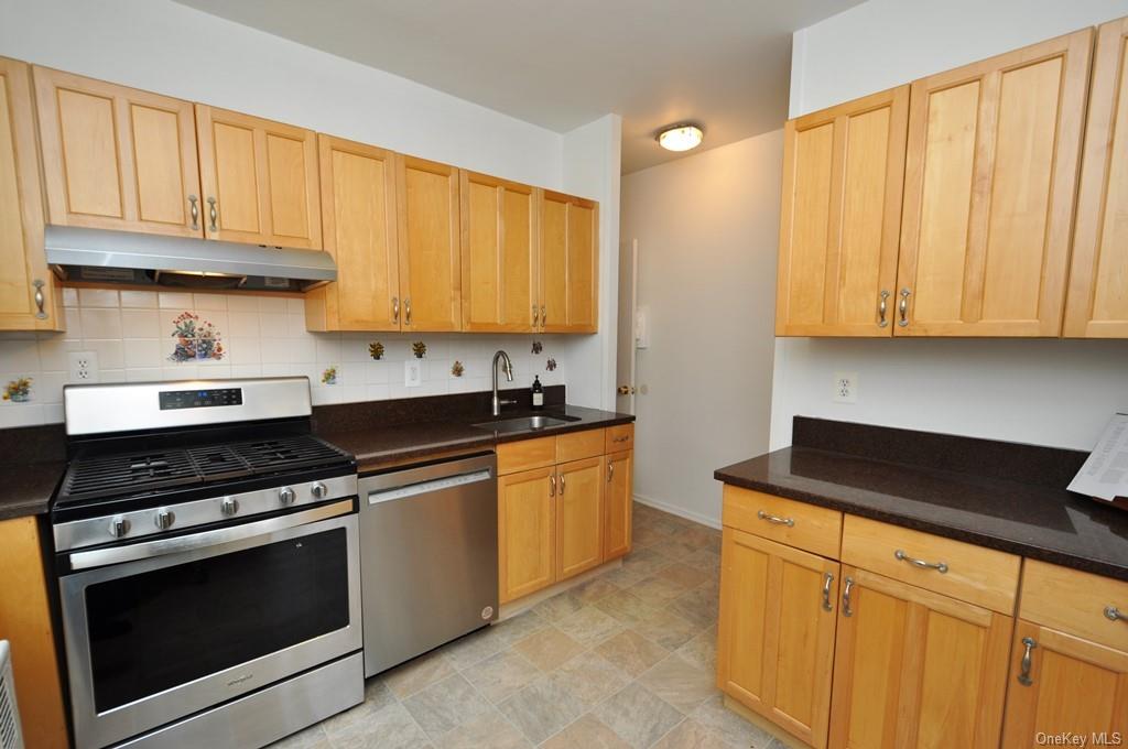 Renovated kitchen with granite counters, stainless Steel appliances and maple cabinets.