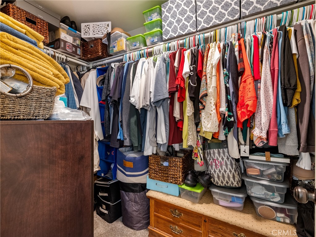 15620 Erie Road Apple Valley, CA 92307 - Photo 29 of 53 a view of walk in closet with clothes and shoes