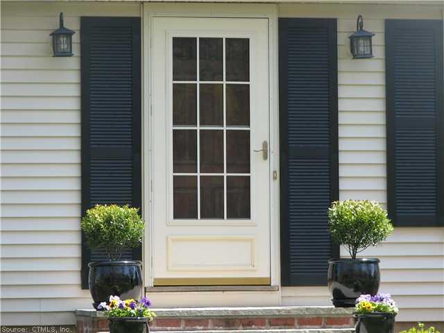 35 Twin Coves Road Madison, CT 06443 - Photo 1 of 1 a view front of house with potted plant
