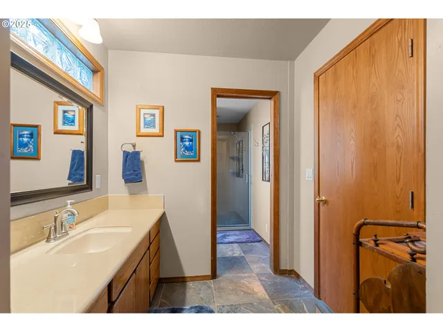 a bathroom with a sink a mirror and a shower