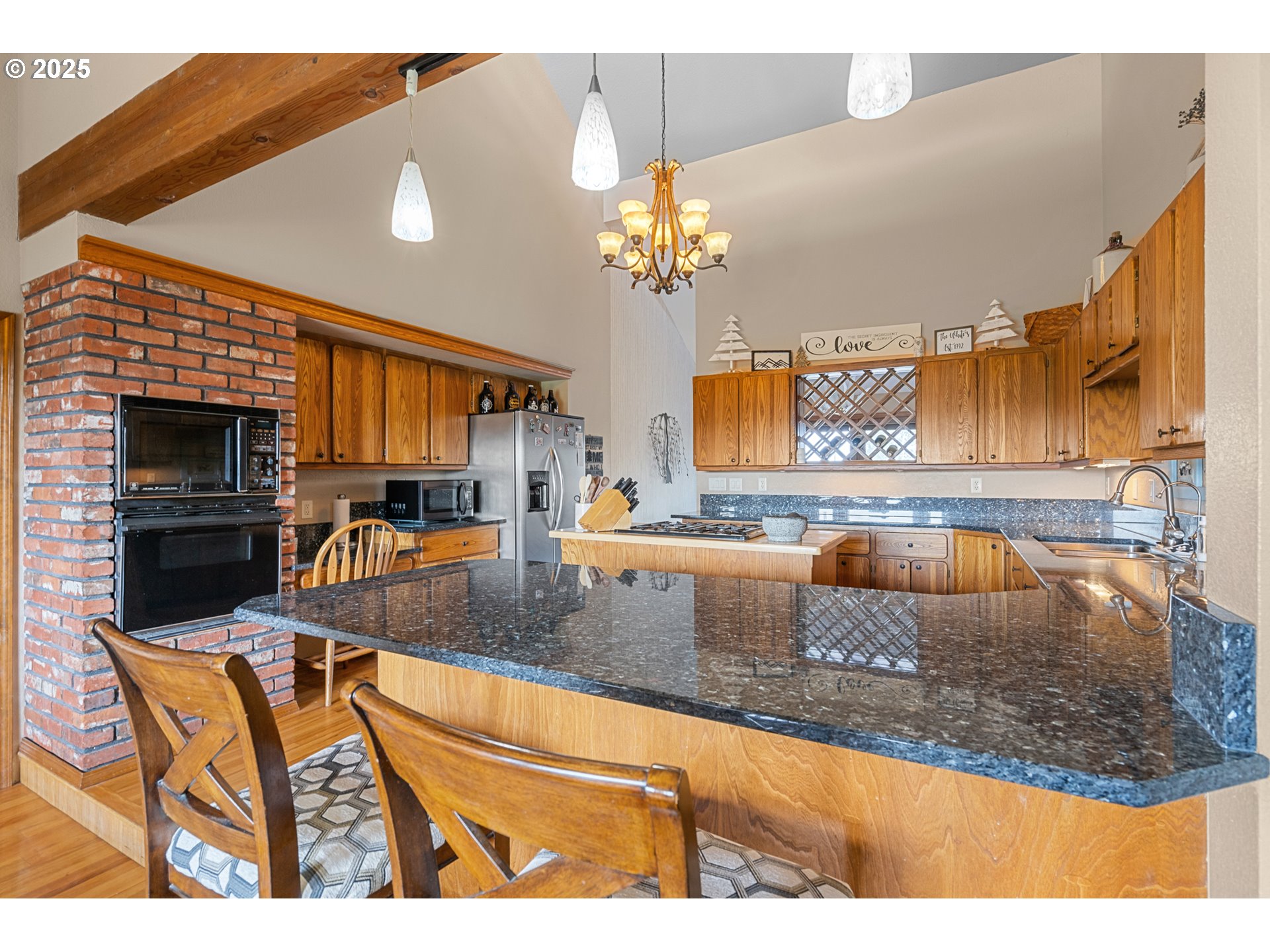 33551 East Progress Road Hermiston, OR 97838 - Photo 20 of 35 a kitchen with a stove a sink and a microwave