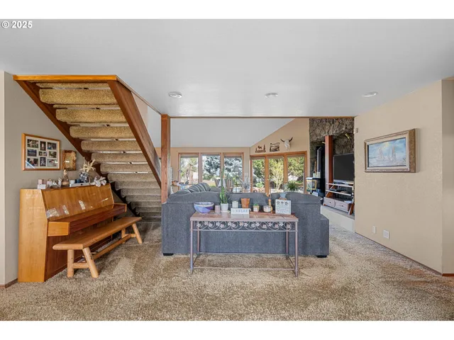 a living room with furniture and a piano