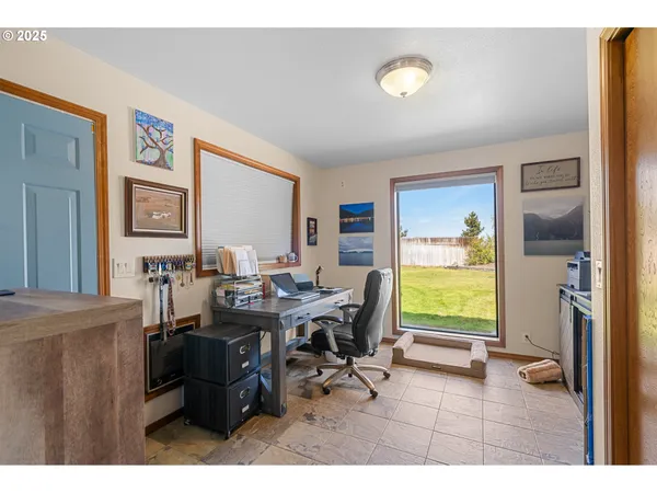 a view of a livingroom with workspace and a window