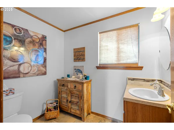 a bathroom with a sink a window and two mirror