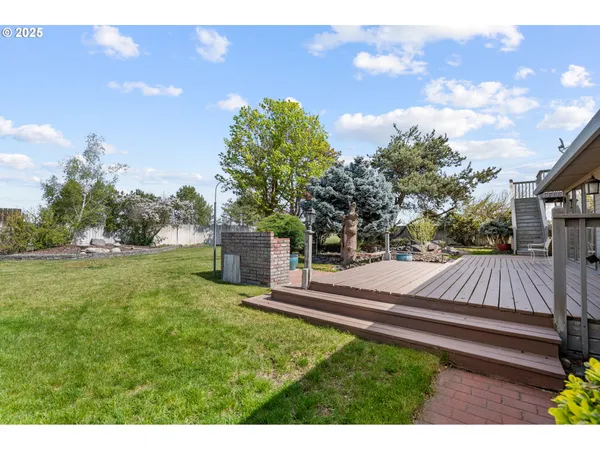 a view of a backyard with sitting area