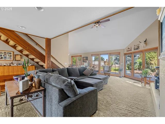 a living room with furniture and a floor to ceiling window