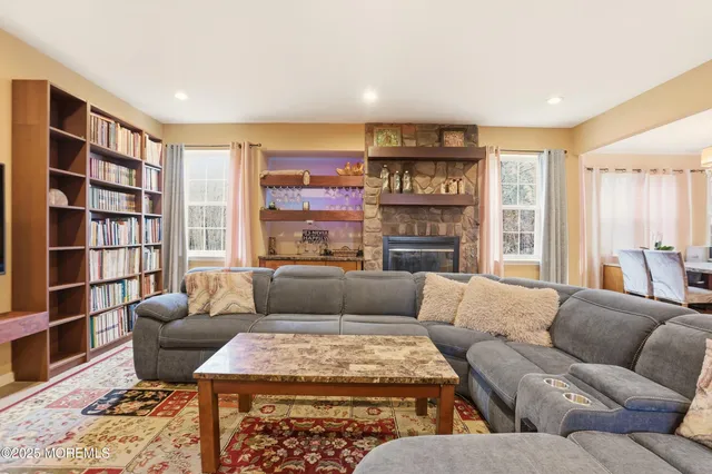 a living room with furniture and a fireplace