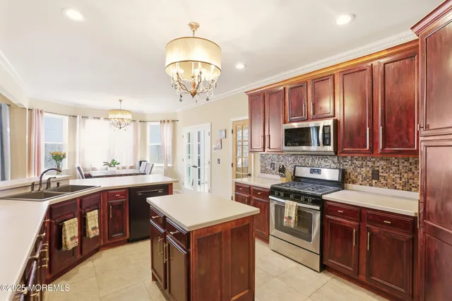 a kitchen with a stove a sink a microwave and wooden cabinets