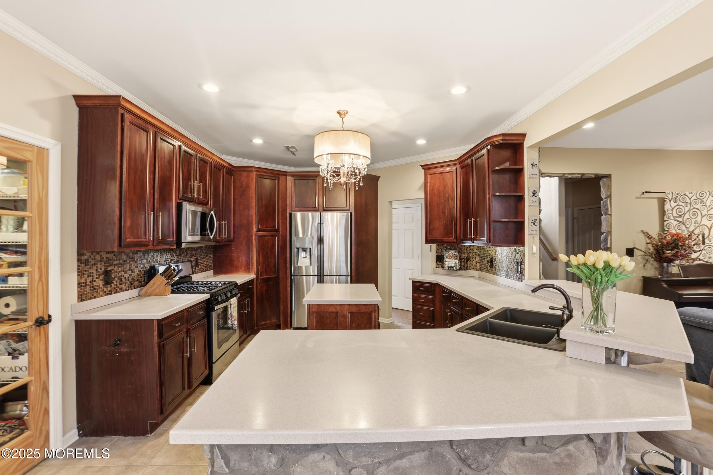 2 Woods Edge Drive Jackson, NJ 08527 - Photo 14 of 43 a large kitchen with kitchen island a large counter top space a sink stainless steel appliances and cabinets