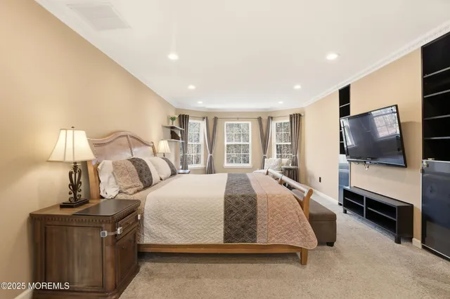 a spacious bedroom with a bed and a flat screen tv