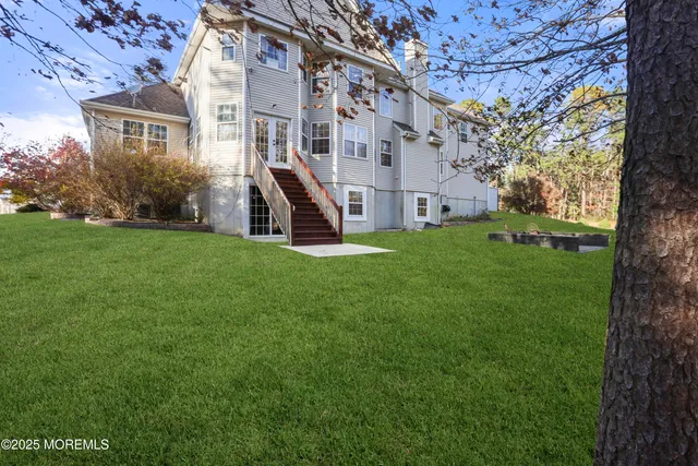 a view of a big room with a big yard and large tree