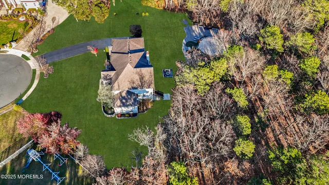 an aerial view of a house with a garden and swimming pool