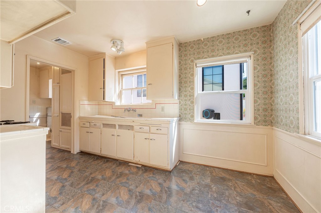 1425 Thompson Avenue Glendale, CA 91201 - Photo 25 of 44 a kitchen with white cabinets and white appliances