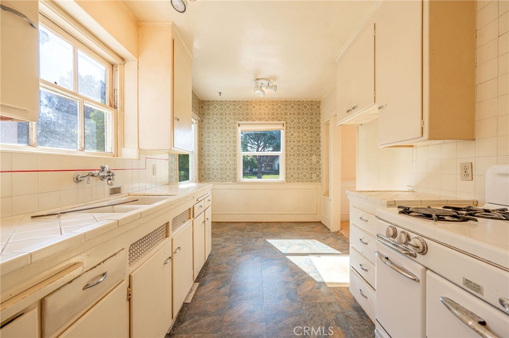 1425 Thompson Avenue Glendale, CA 91201 - Photo 30 of 44 a kitchen with granite countertop a sink stove and cabinets