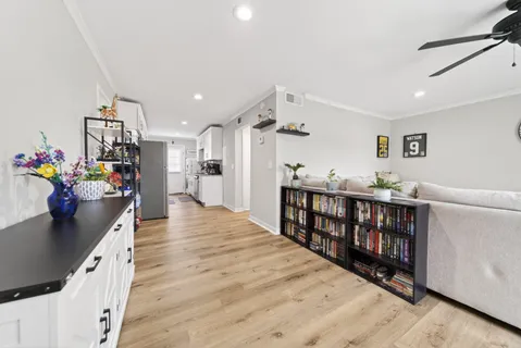 a living room with furniture and wooden floor