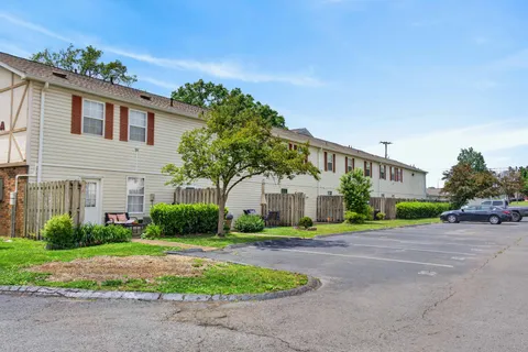 a front view of building with yard and green space