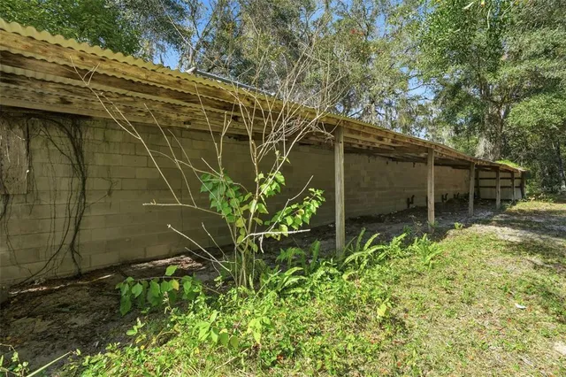 a view of a green field with trees in the background