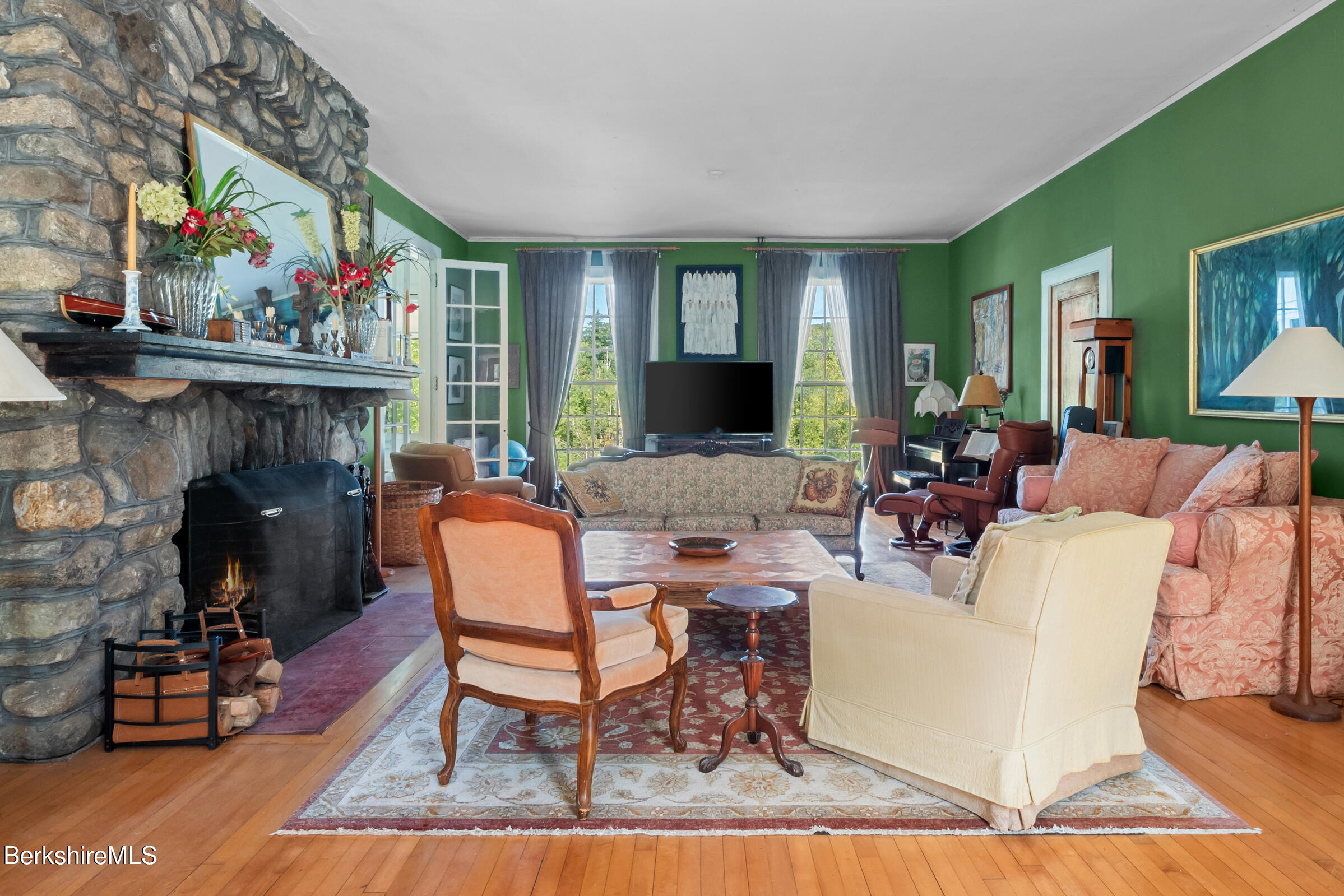 535 Main Road Monterey, MA 01245 - Photo 11 of 45 a living room with furniture a flat screen tv and a fireplace