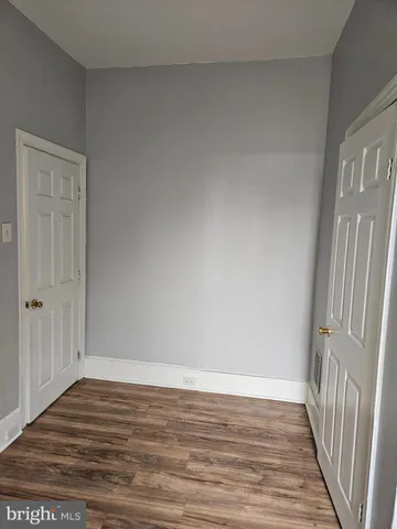 a view of a room with wooden floor and stairs