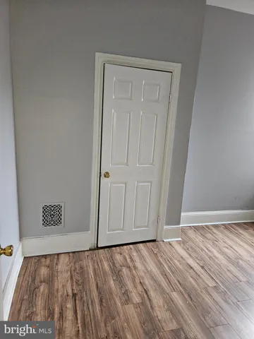 a view of an empty room and wooden floor