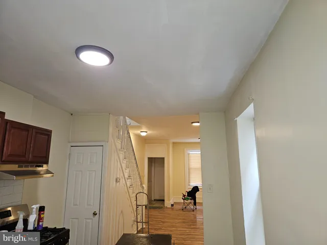 a view of a hallway with workspace and a living room