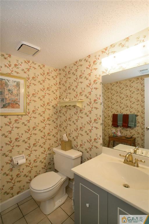 154 Westgate Drive Edison, NJ 08820 - Photo 11 of 19 a bathroom with a sink a toilet and a mirror
