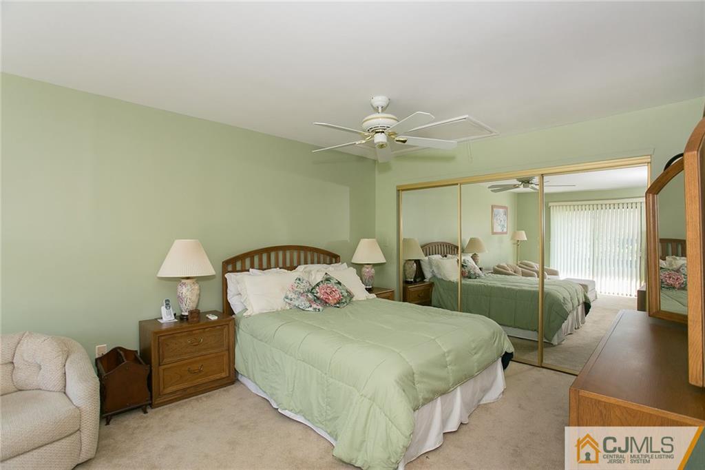 154 Westgate Drive Edison, NJ 08820 - Photo 12 of 19 a spacious bedroom with a bed a couch and a chandelier