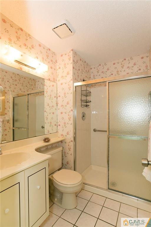 154 Westgate Drive Edison, NJ 08820 - Photo 14 of 19 a bathroom with a sink a toilet and shower