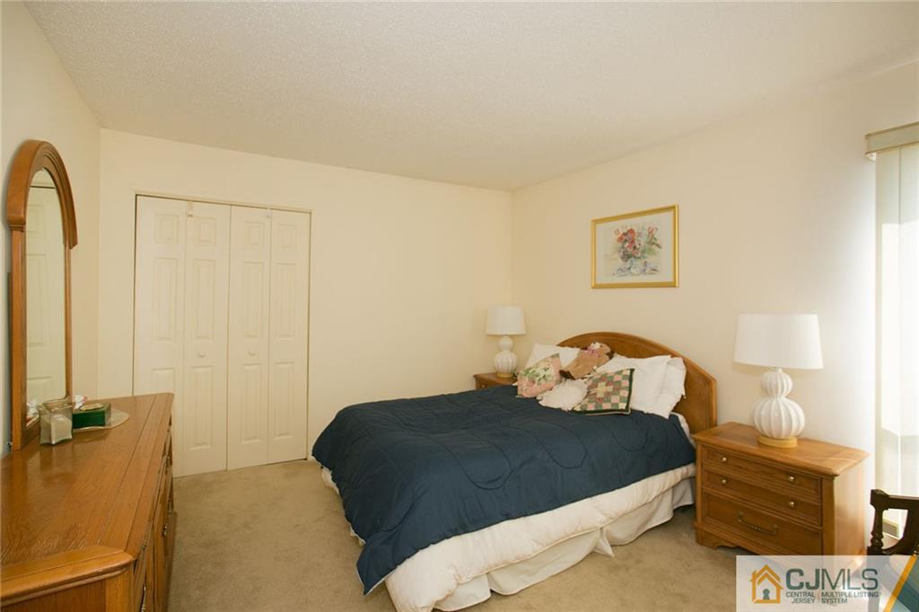 154 Westgate Drive Edison, NJ 08820 - Photo 15 of 19 a bedroom with a bed and a cabinets