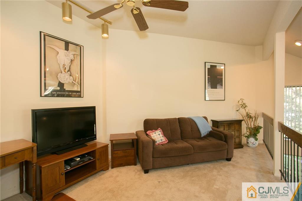 154 Westgate Drive Edison, NJ 08820 - Photo 16 of 19 a living room with furniture and a flat screen tv