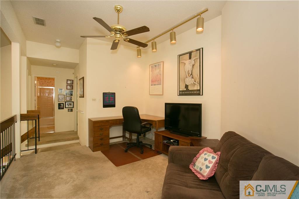 154 Westgate Drive Edison, NJ 08820 - Photo 17 of 19 a living room with furniture and a flat screen tv