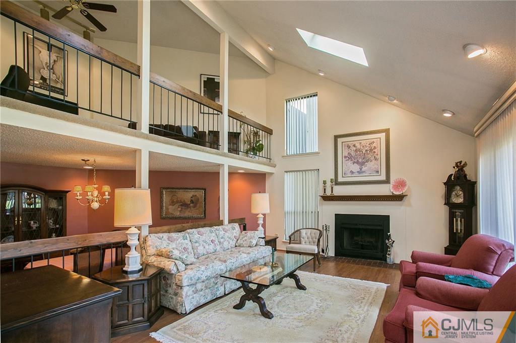 154 Westgate Drive Edison, NJ 08820 - Photo 3 of 19 a living room with furniture a flat screen tv and a fireplace